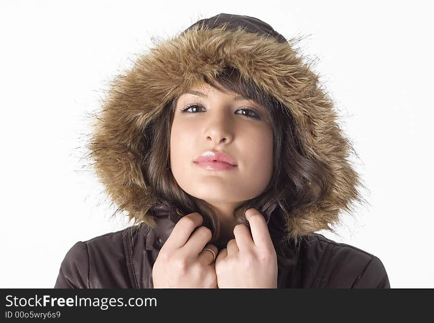 Young brunette girl in brown winter jacket.Happy face and worm look. Young brunette girl in brown winter jacket.Happy face and worm look.