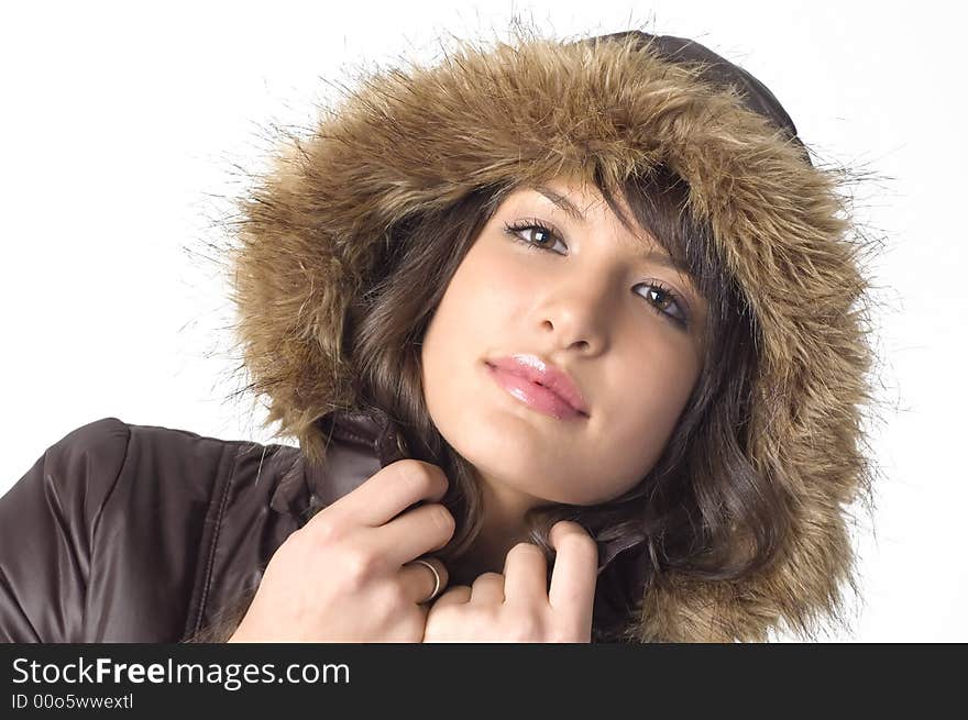 Young brunette girl in brown winter jacket.Happy face and worm look. Young brunette girl in brown winter jacket.Happy face and worm look.