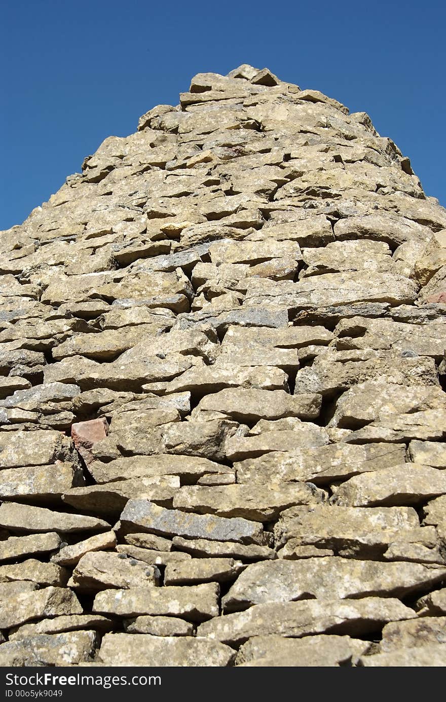 Detail of an old stone-made shepherd shelter against blue sky. Detail of an old stone-made shepherd shelter against blue sky