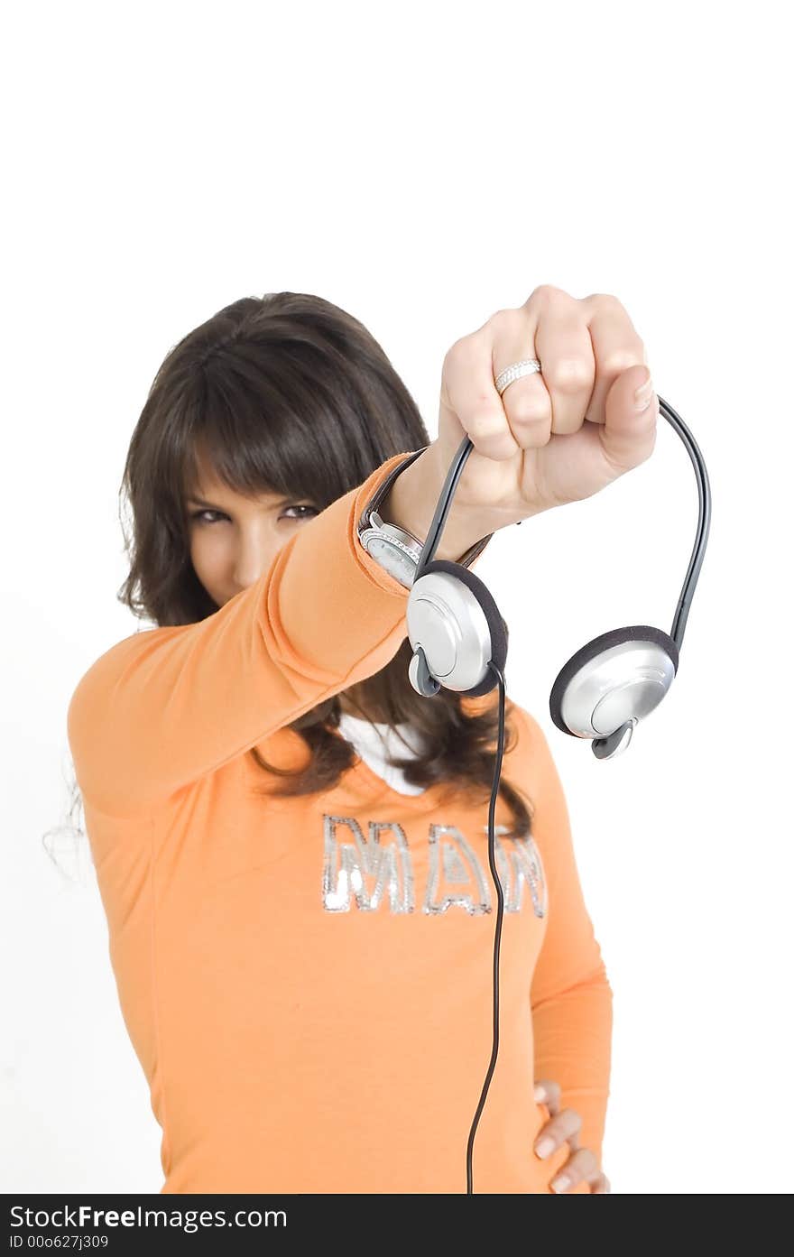 Young brunette girl with headphones in hand. Young brunette girl with headphones in hand.