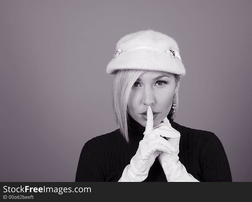 A blonde model in white hat and gloves in black and white. A blonde model in white hat and gloves in black and white