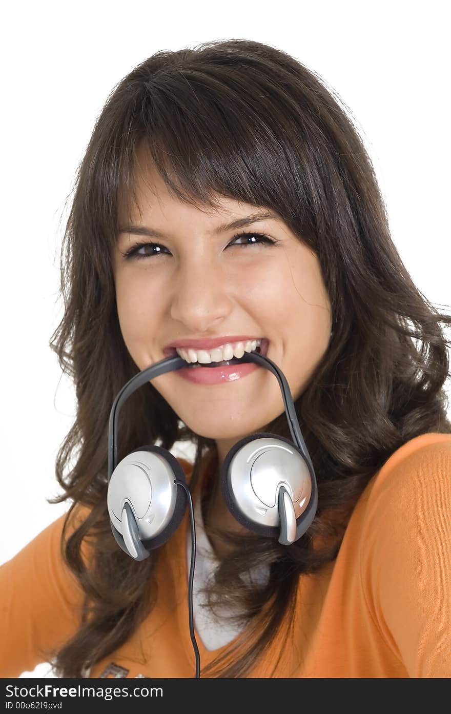 Young angry brunette girl with headphones in mouth. Young angry brunette girl with headphones in mouth.