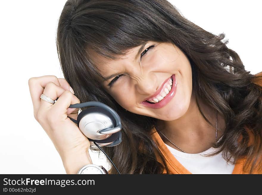 Young brunette girl with headphones in hand. Young brunette girl with headphones in hand.