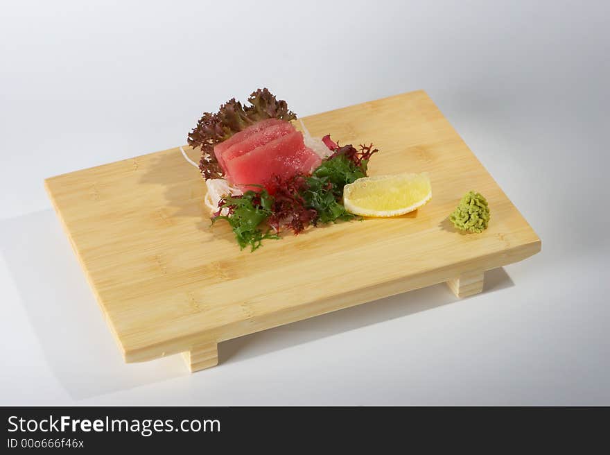 Sashimi on the tray on the light background. Sashimi on the tray on the light background.