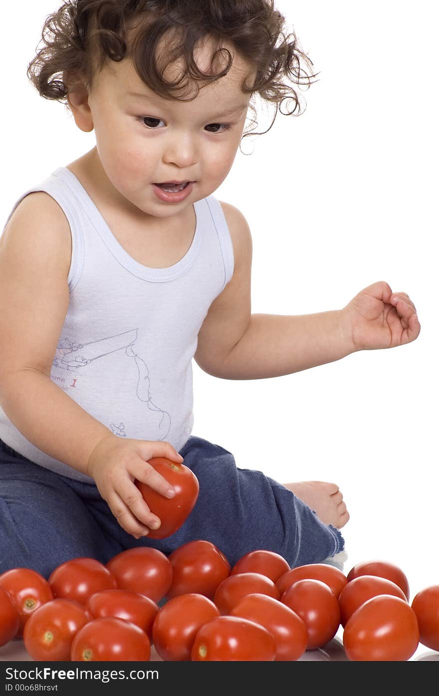 Child with tomato, isolated on a white background. Child with tomato, isolated on a white background.