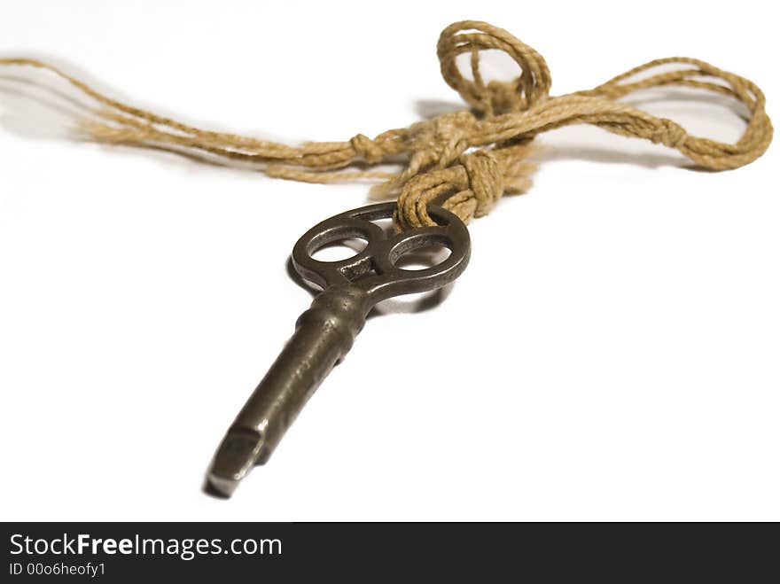 An old mysterious key isolated against a white background. An old mysterious key isolated against a white background