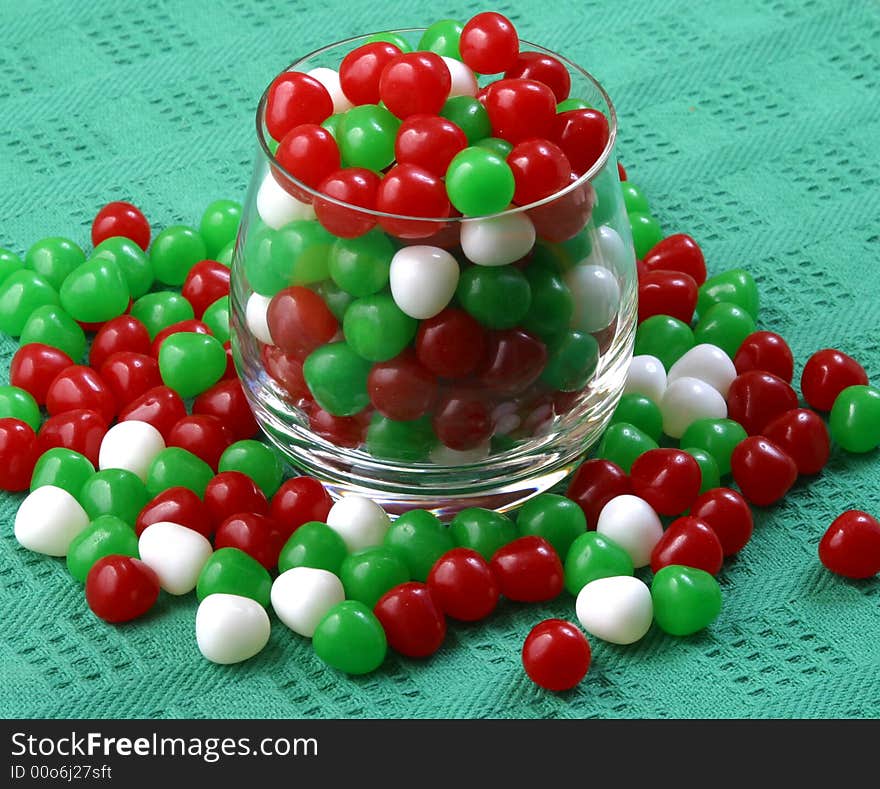 A glass filled with colorful Christmas candy.