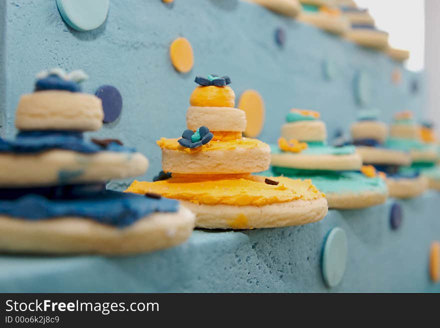 Up close decorated cookies on top of a gourmet cak