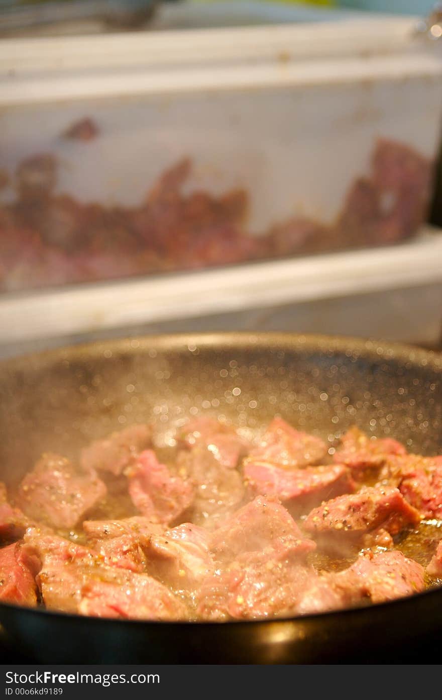 Image of beef tenderloin pieces grilling in a frying pan