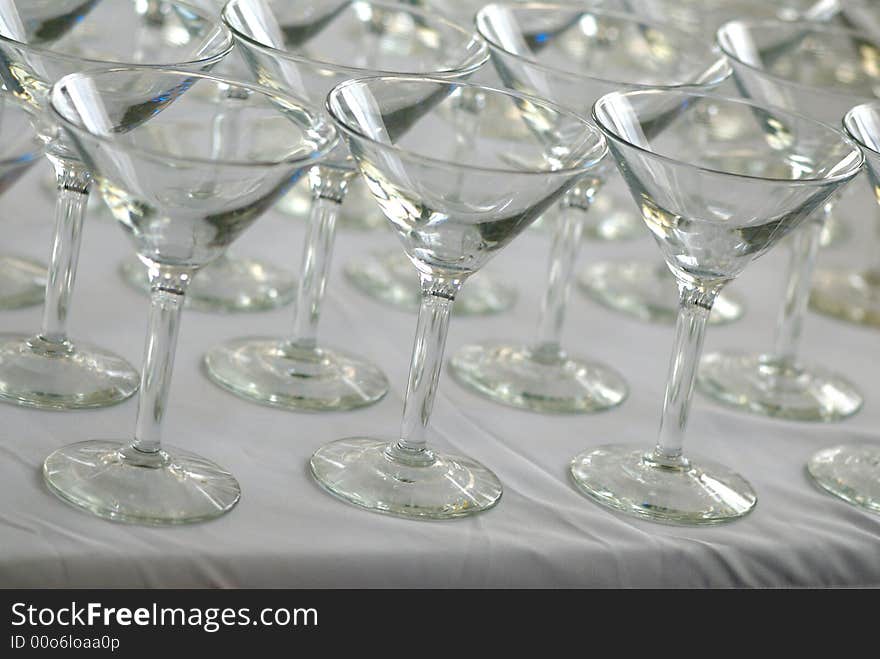 Rows of martini glasses on a white cloth