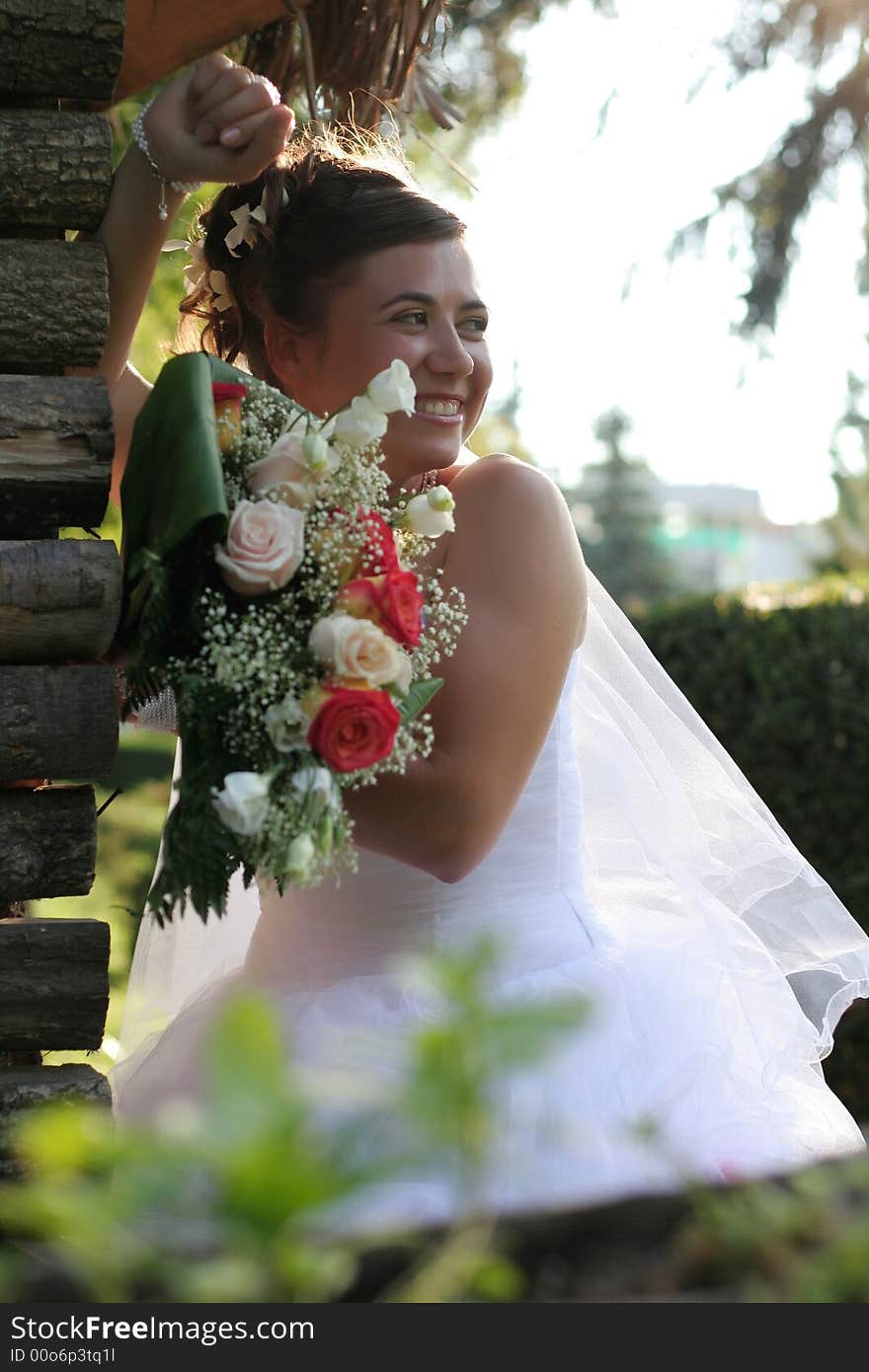 Young bride posing in park in the wedding day