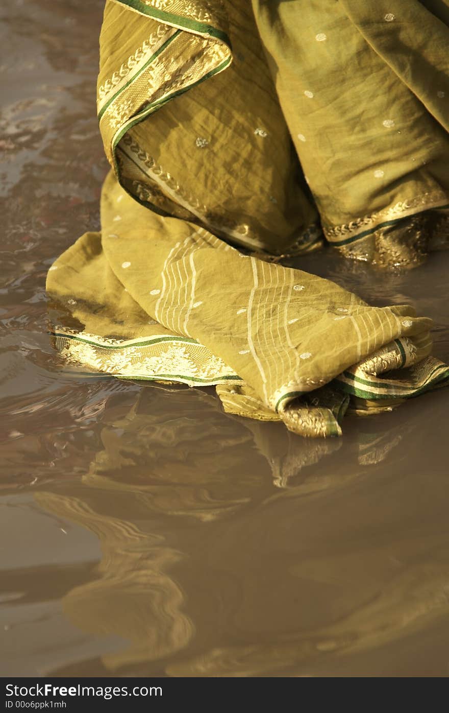 Woman in ornate sari standing in river bathing. Varanasi, Uttar Pradesh, India. Woman in ornate sari standing in river bathing. Varanasi, Uttar Pradesh, India