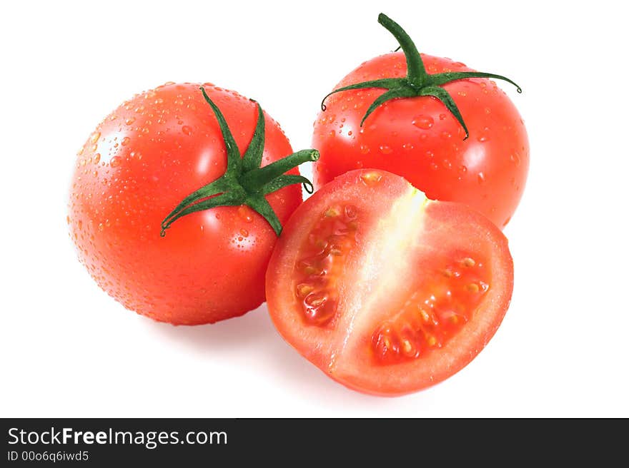 Ripe juicy tomatoes isolated on white; wet. Ripe juicy tomatoes isolated on white; wet