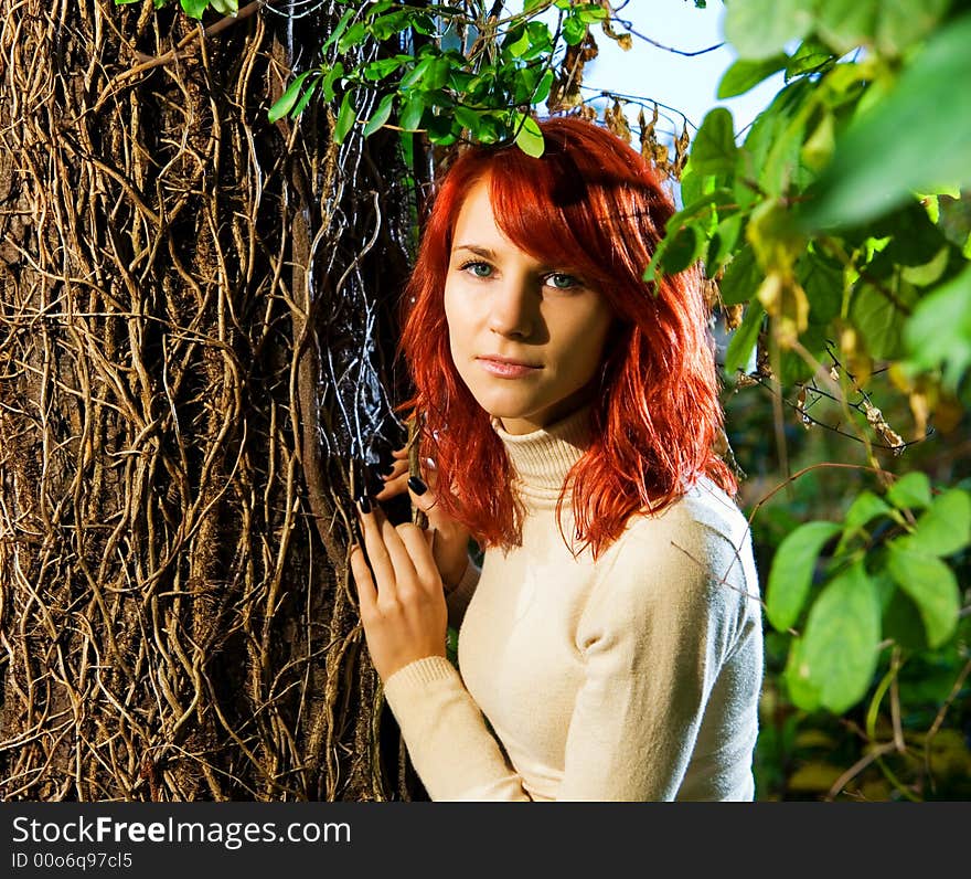 Beautiful redhead girl in the forest