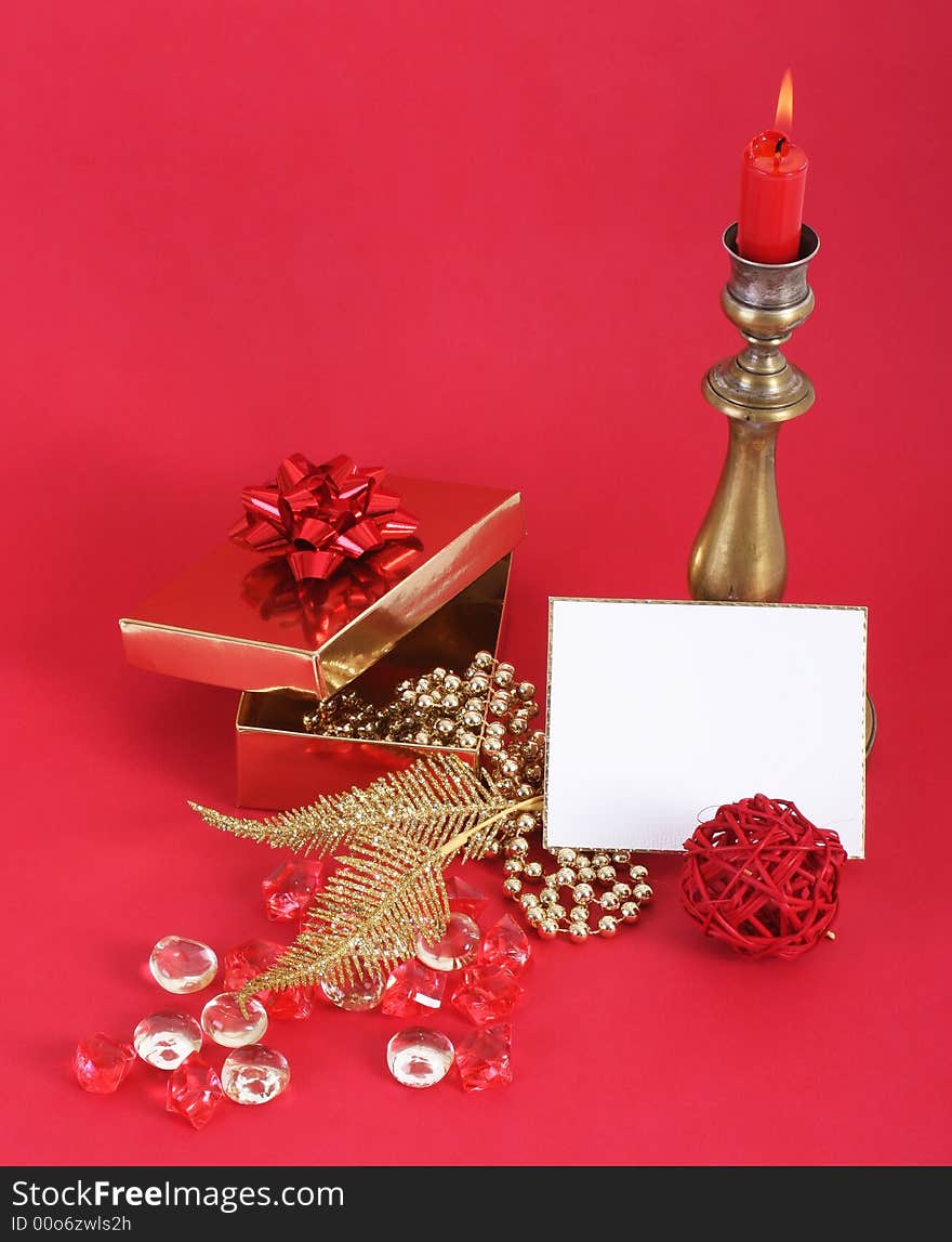 Christmas candle with flame. A white card in front. Red background. Christmas candle with flame. A white card in front. Red background.