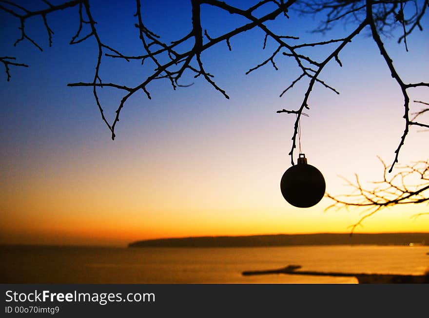 A Christmas ball with red and sunset background