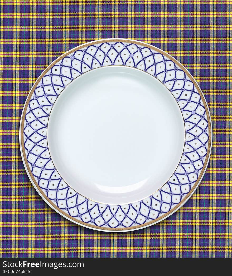 A empty dish on the table cloth