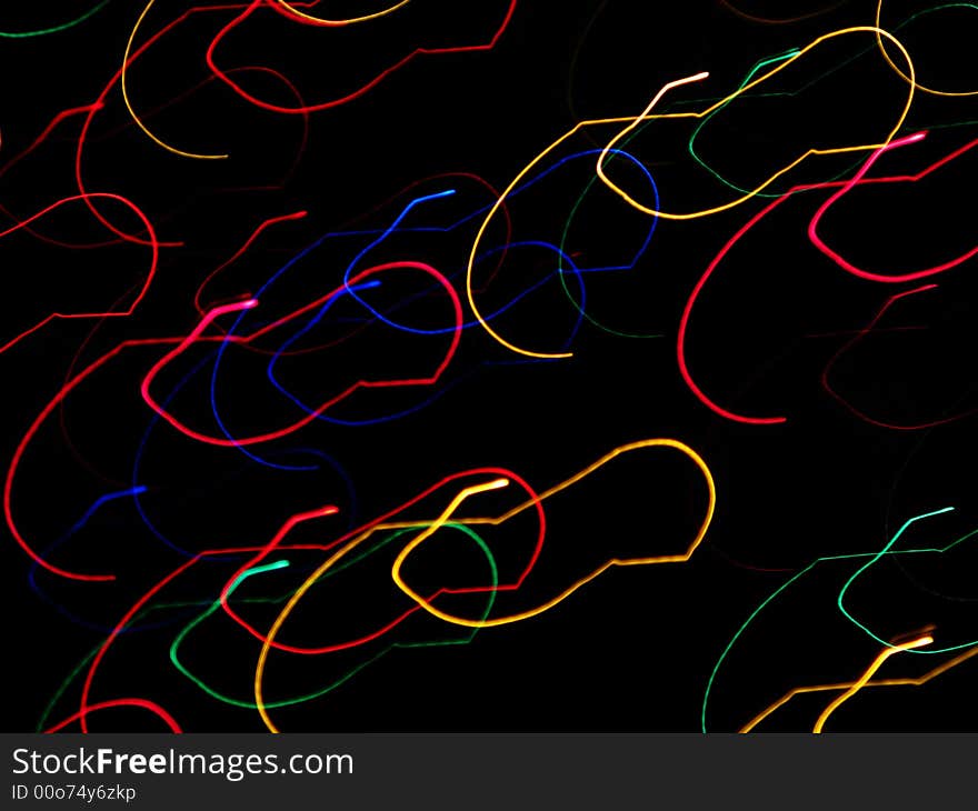 Abstraction of holiday lights in a swirling motion. Abstraction of holiday lights in a swirling motion.