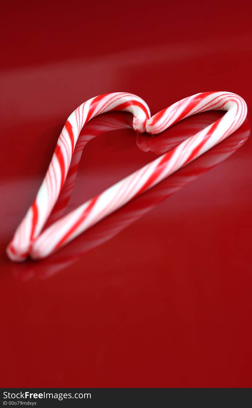 A candy cane heart on a red background. A candy cane heart on a red background