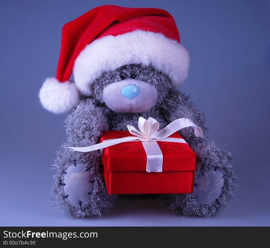 Cute Santa bear in red hat with gift. Cute Santa bear in red hat with gift