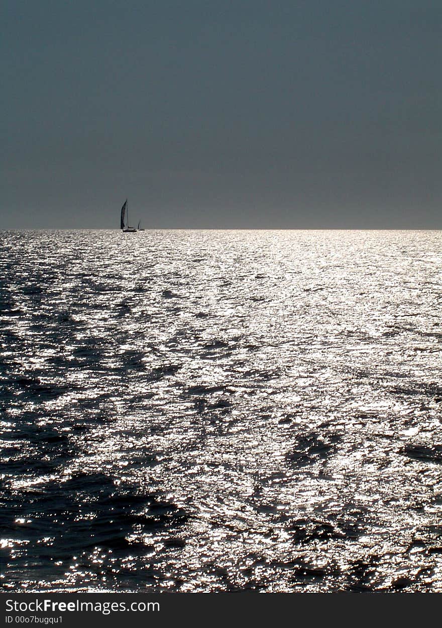 Sea of light with sailing boat