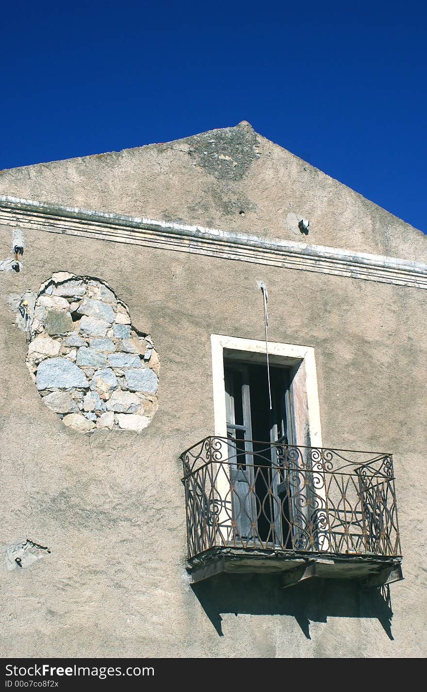 Old house with balcony in wrought iron