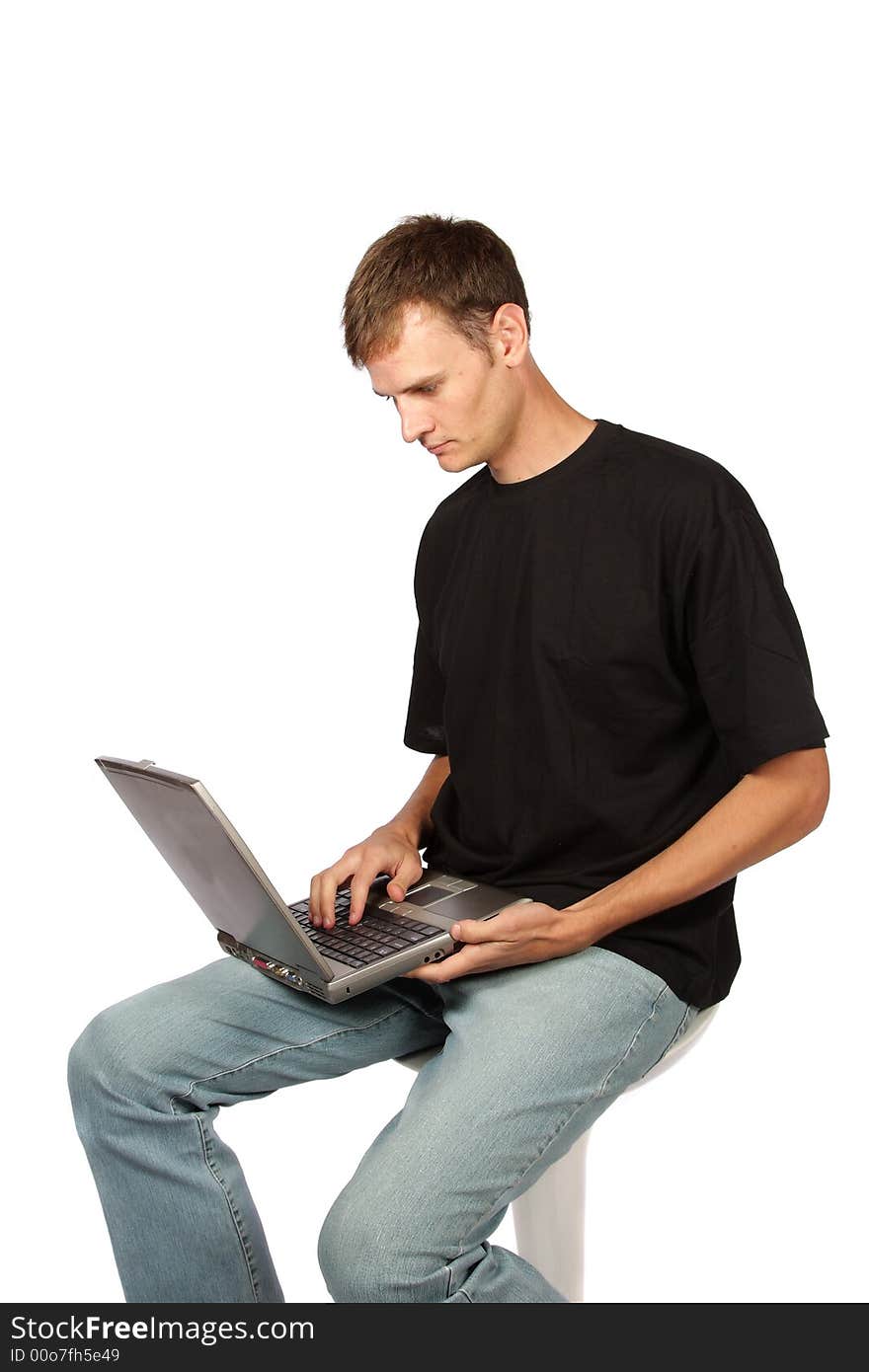 Yuppie working on laptop wearing casual clothes. Yuppie working on laptop wearing casual clothes