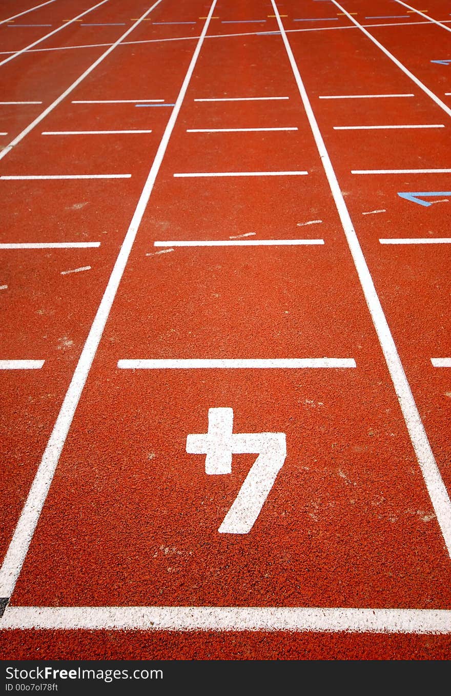 Number four of a racetrack, on red tarmac, for runners. Leading lines. Number four of a racetrack, on red tarmac, for runners. Leading lines