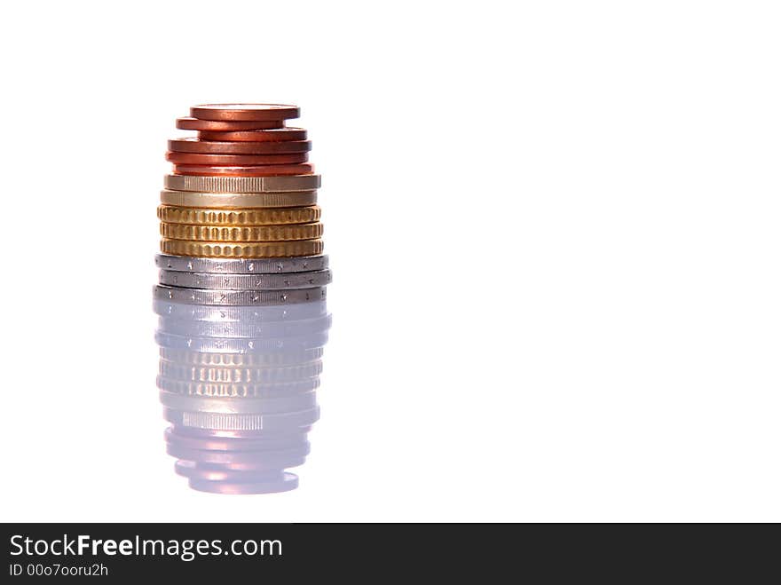 Stack of euro coins isolated over white background, with reflection