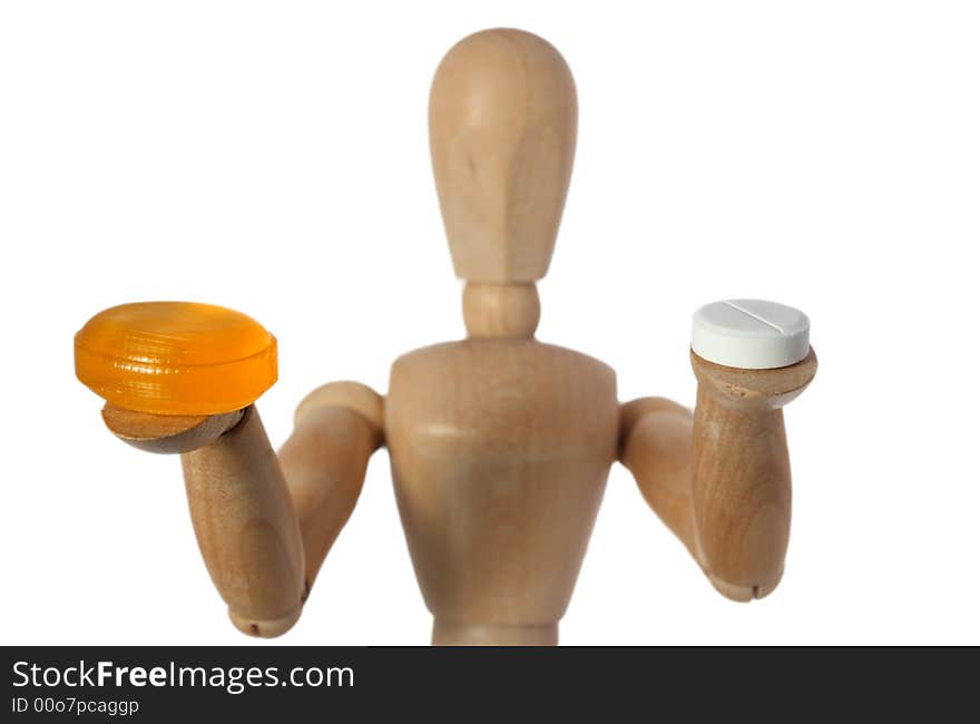 Wood mannequin choose orange or white pill. Wood mannequin choose orange or white pill