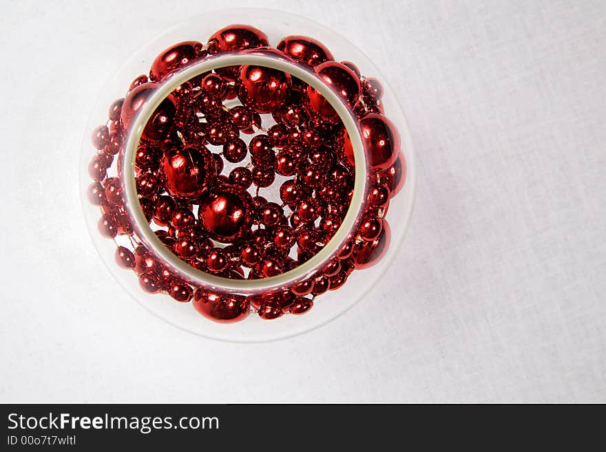 Glass bowl with a red necklace inside. Glass bowl with a red necklace inside