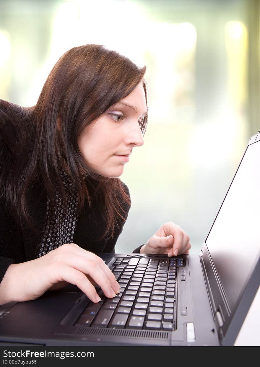 Young woman works at her laptop