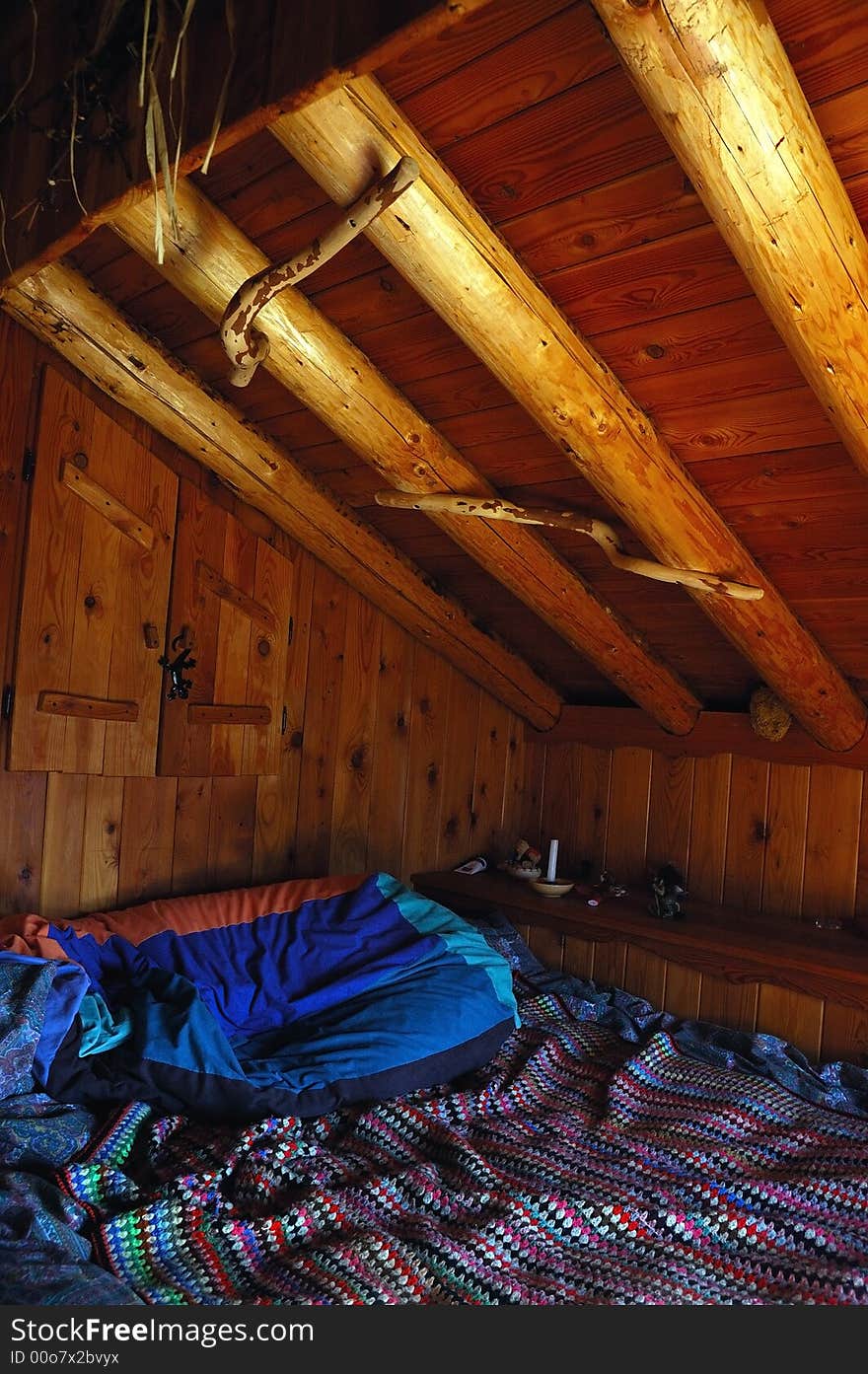 Interior view of a mountain cottage: the simple sleeping room. Interior view of a mountain cottage: the simple sleeping room