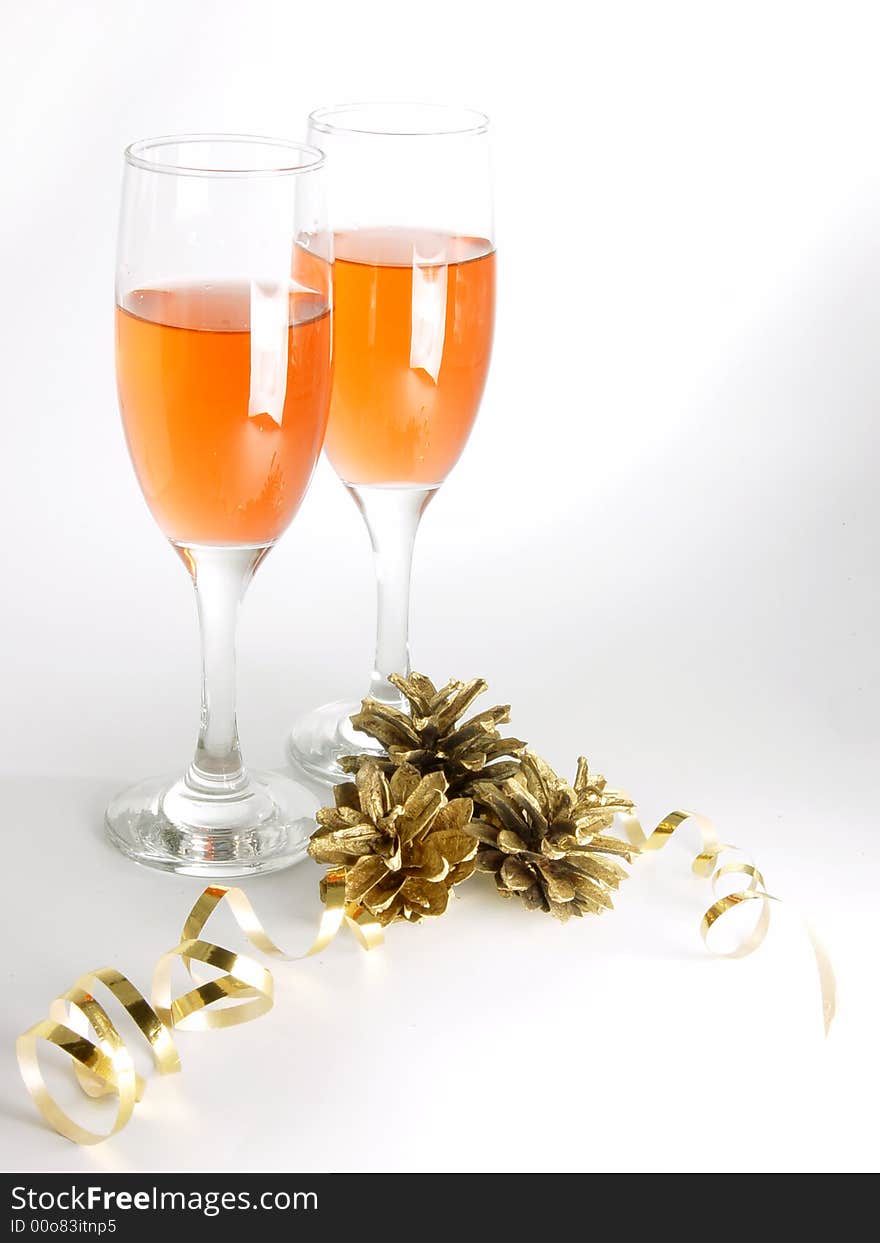 Two glasses with wine and cones  with yellow ribbon with shadows