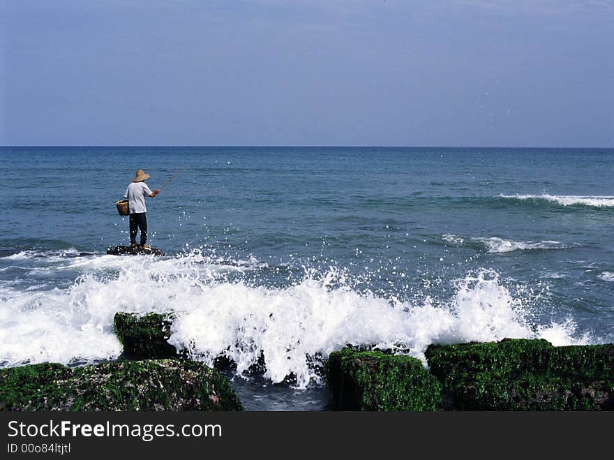 Fisher Man working in a Sea, in China. Fisher Man working in a Sea, in China.