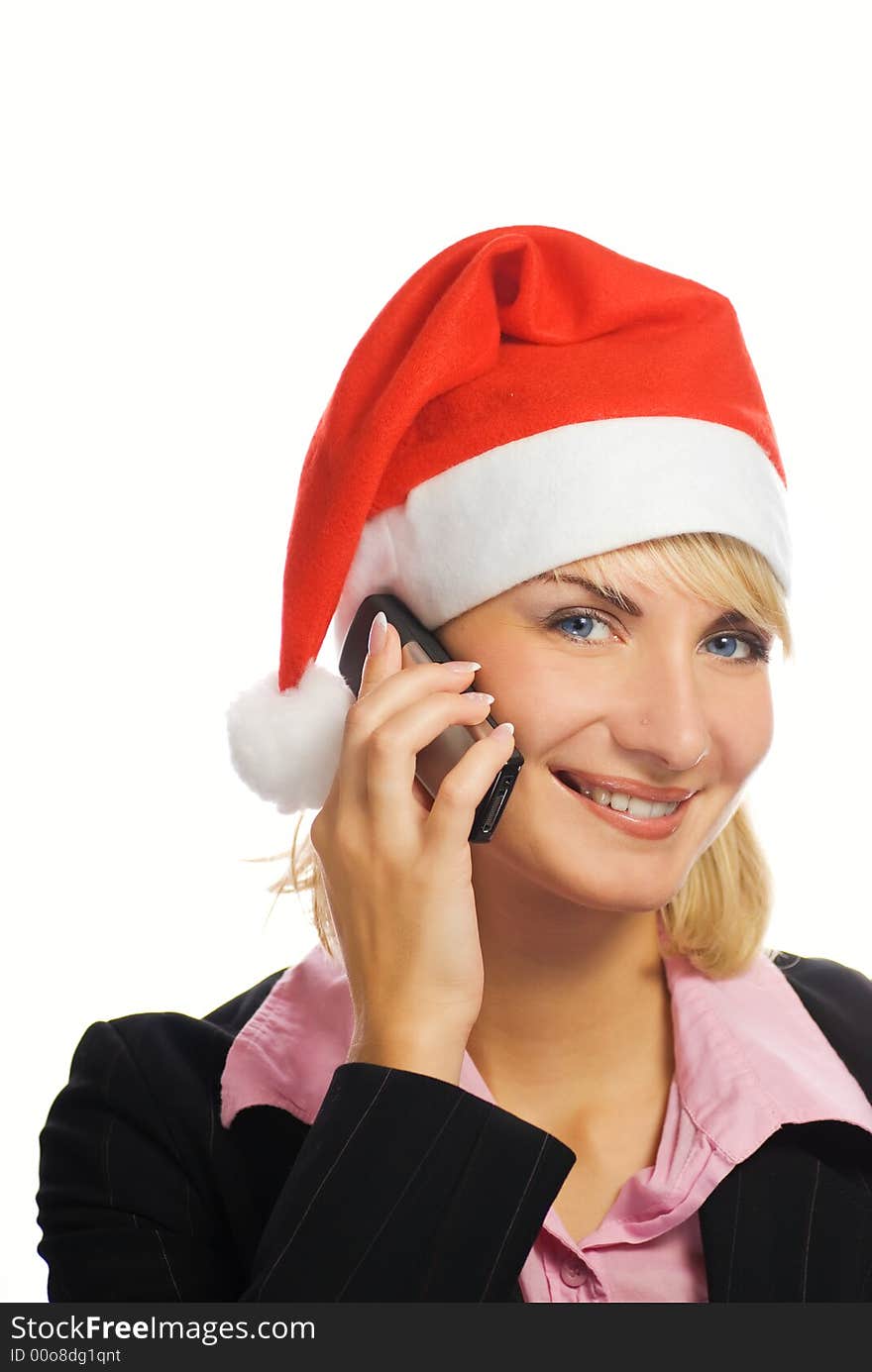 Business woman in Christmas hat talks on the phone. Isolated on white background