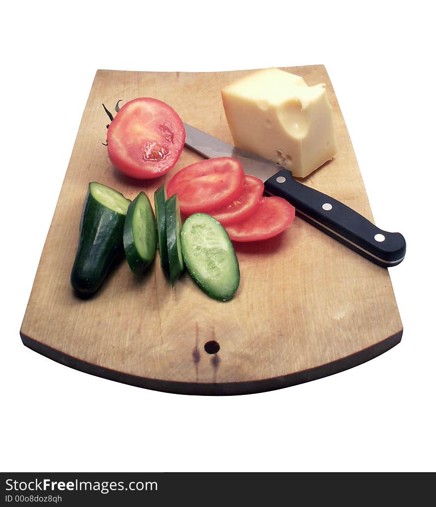 Tomato and cucumber with cheese and kitchen knife on wooden plate on white background. Tomato and cucumber with cheese and kitchen knife on wooden plate on white background