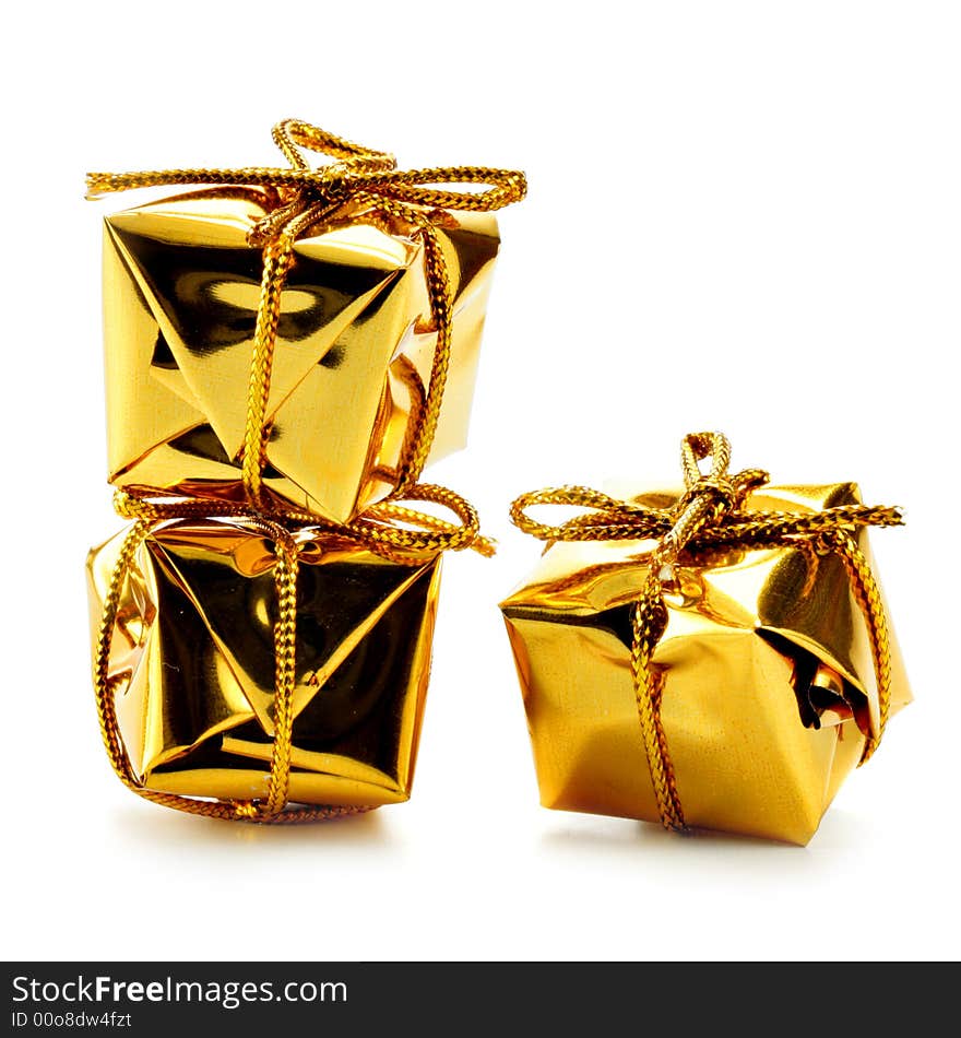 Three golden gift boxes isolated over white background