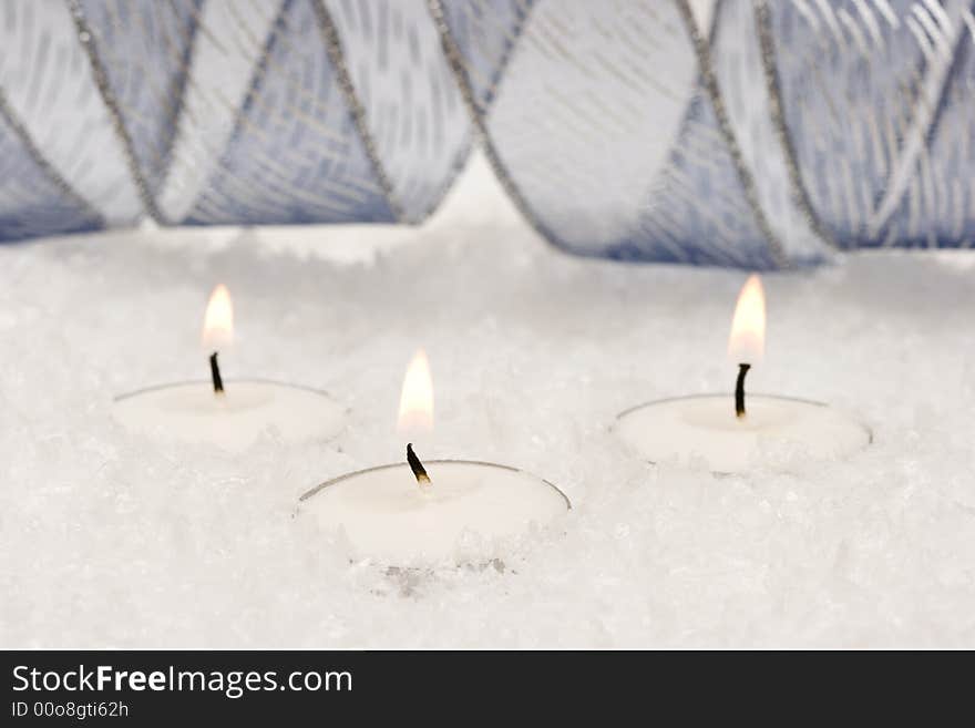 Festive new-year candles with snow