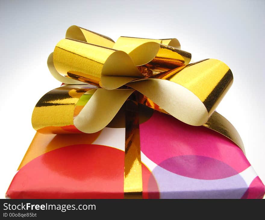 Gift in box packed into bright color paper