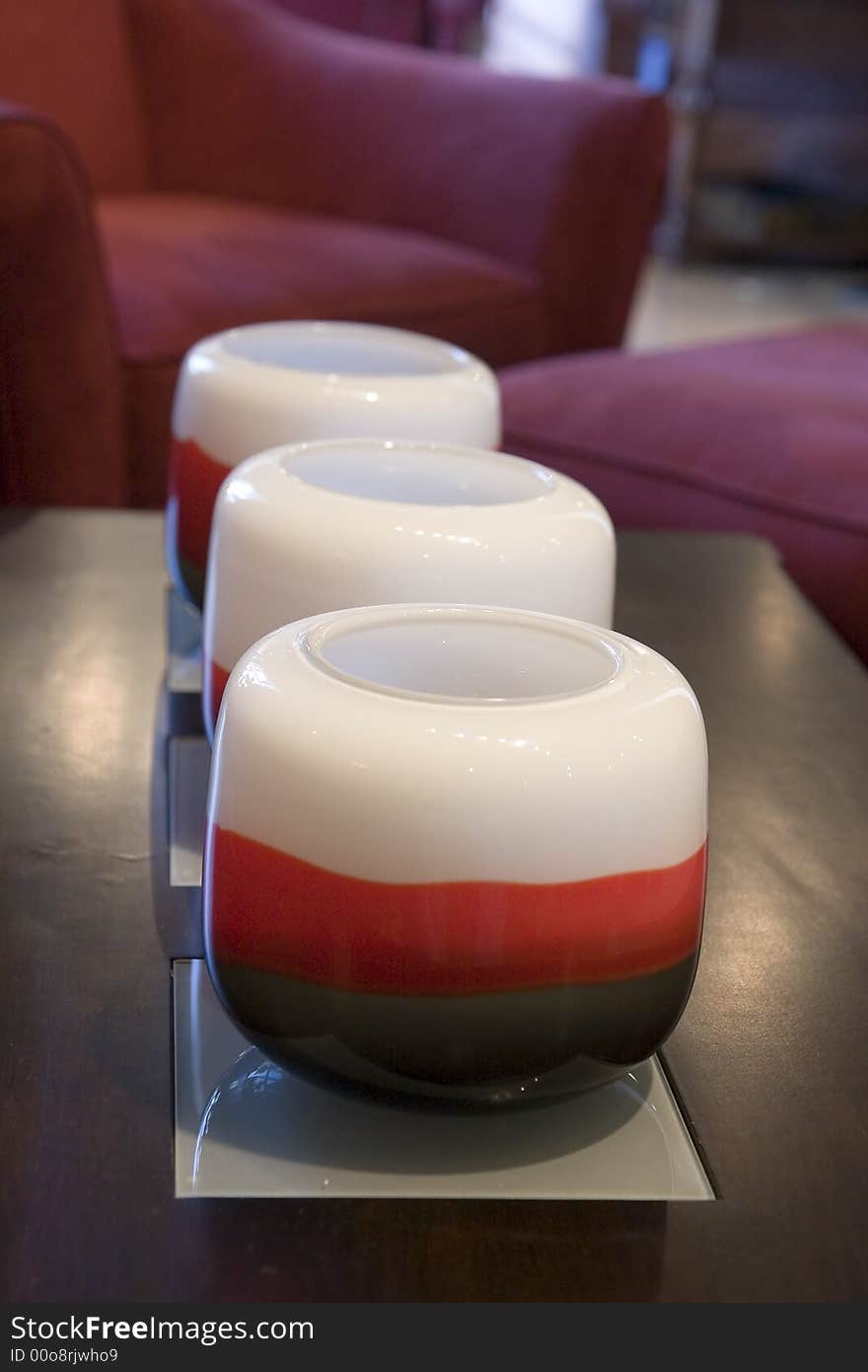 A row of red and white candles on a coffee table