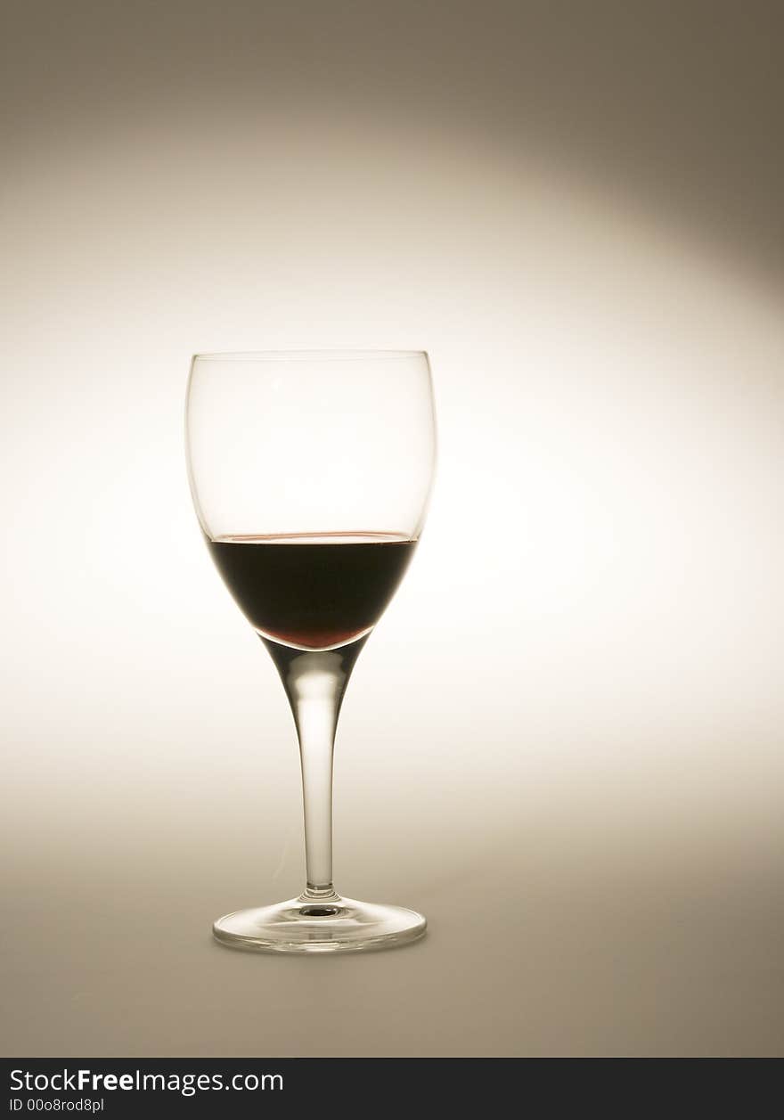 Wine glass filled with red wine with special lighting