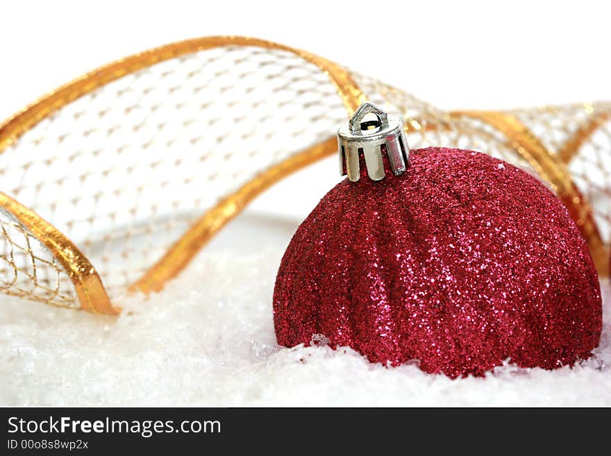 Red Christmas ball on snow background