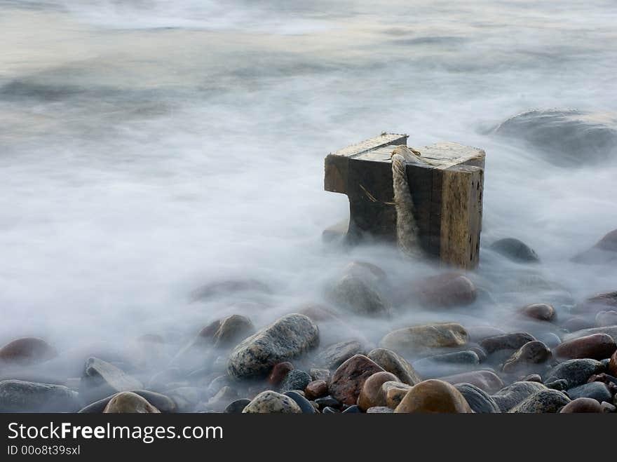 The cold dark blue sea, easy(light) fog, breakwater in the distance. The cold dark blue sea, easy(light) fog, breakwater in the distance.