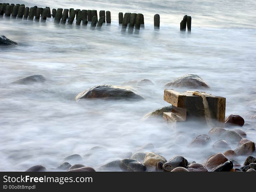 The cold dark blue sea, easy(light) fog, breakwater in the distance. The cold dark blue sea, easy(light) fog, breakwater in the distance.