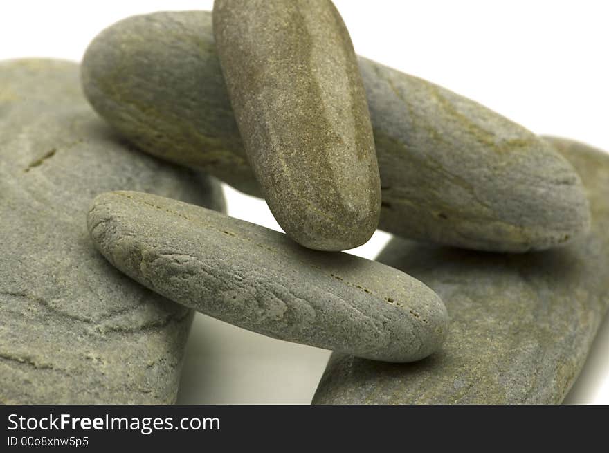 Grey pebbles on white background