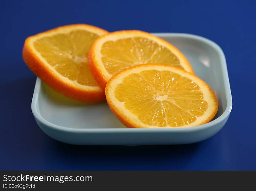 Close up of orange slices on a blue plate