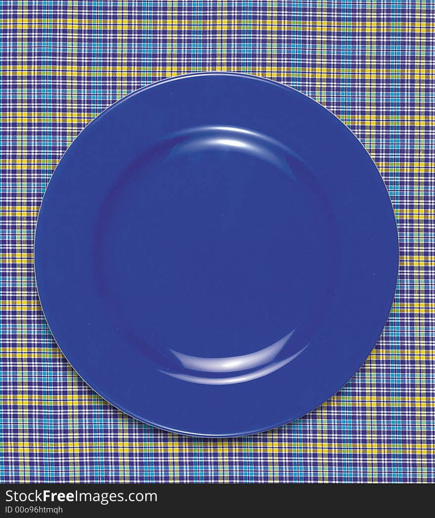 A empty dish on the table cloth