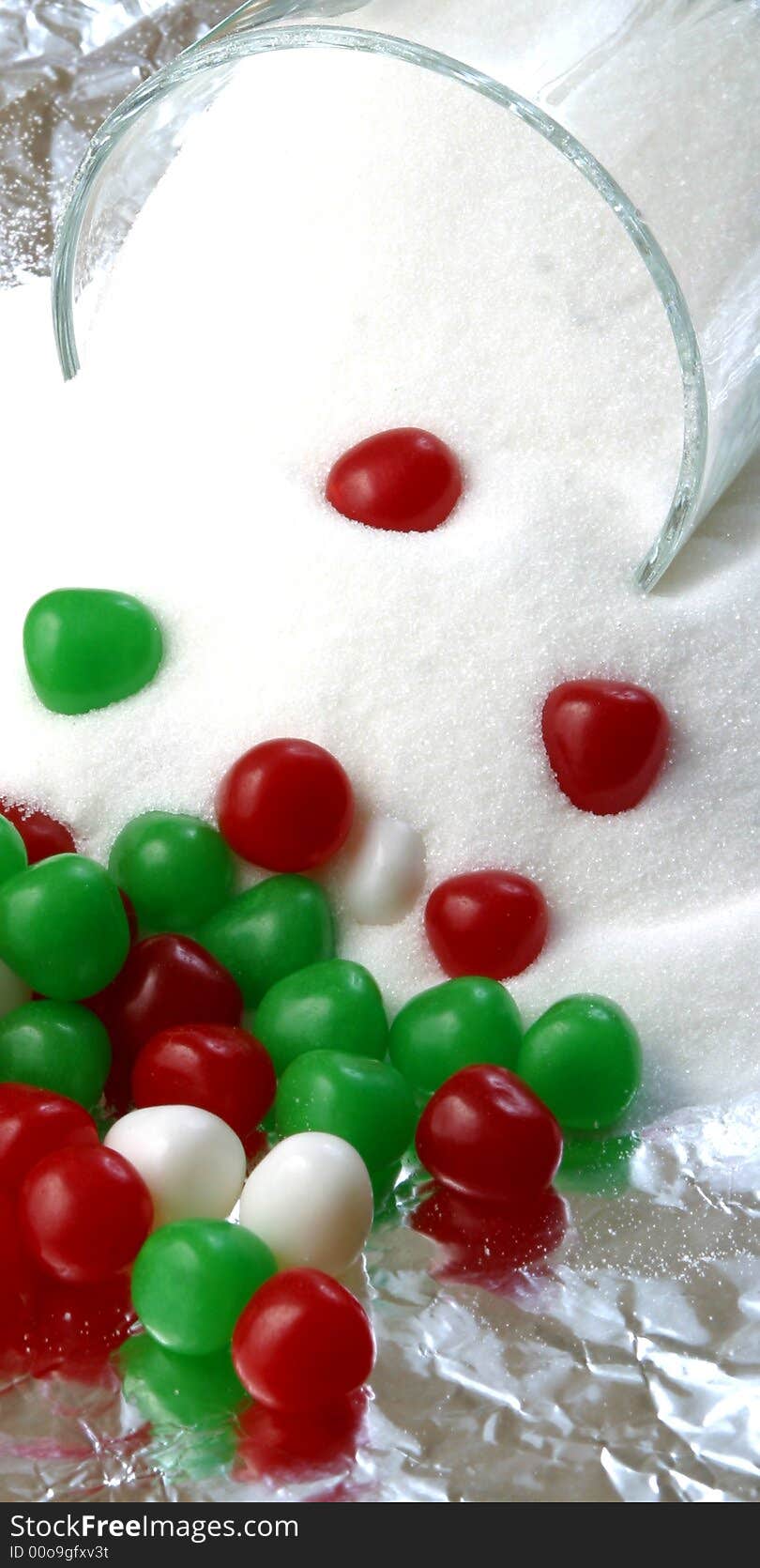 Christmas candy and a bowl of spilled sugar. Christmas candy and a bowl of spilled sugar.