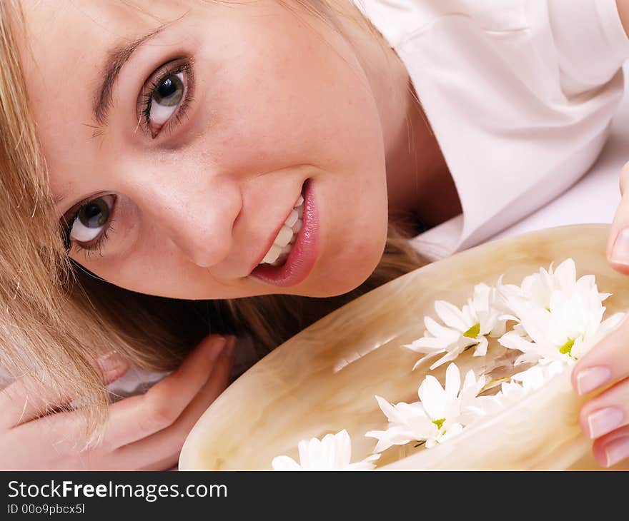 Close up of beautiful face and bowl full of flower. Close up of beautiful face and bowl full of flower